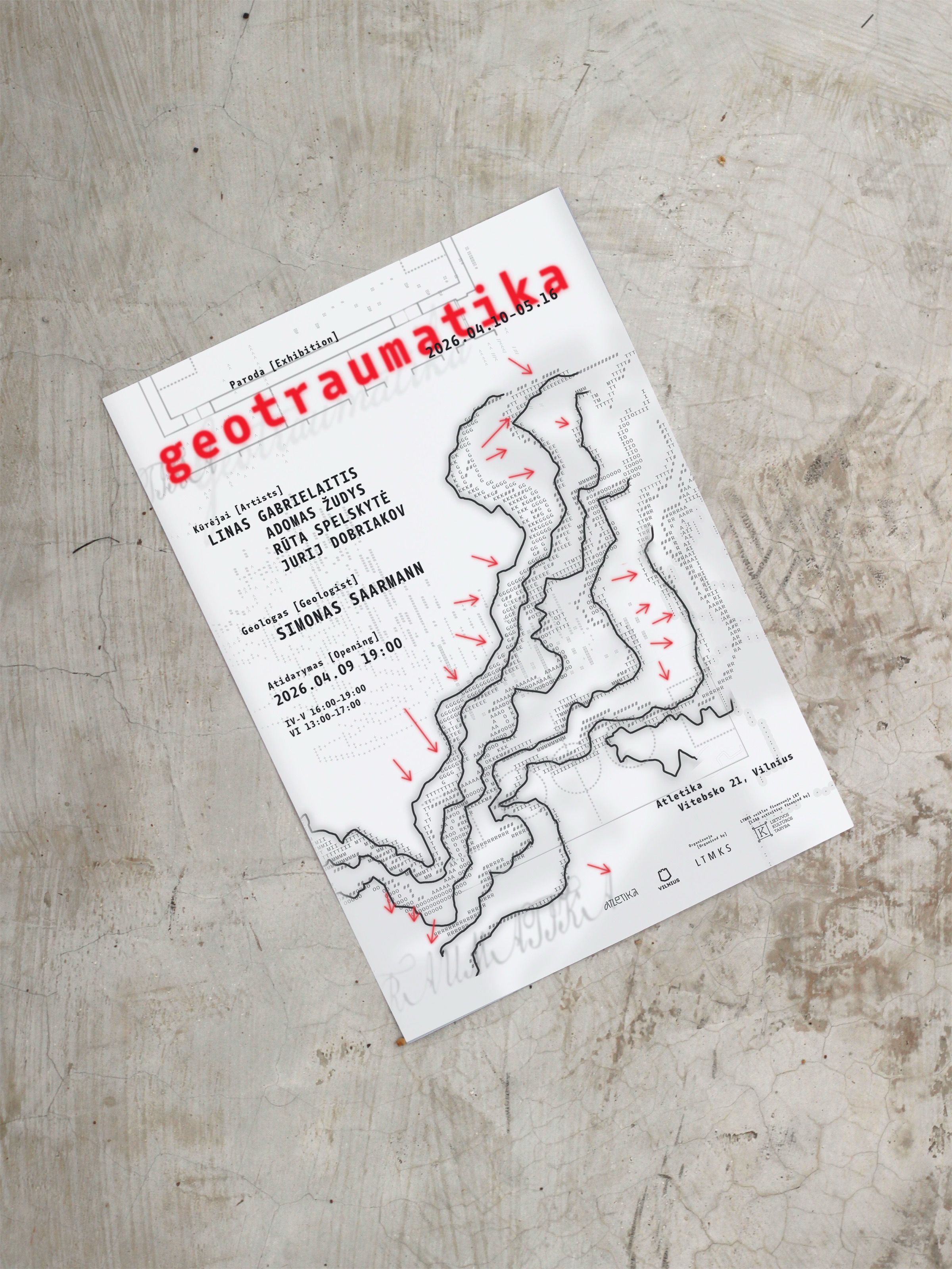 Geotraumatika exhibition poster lying on concrete
