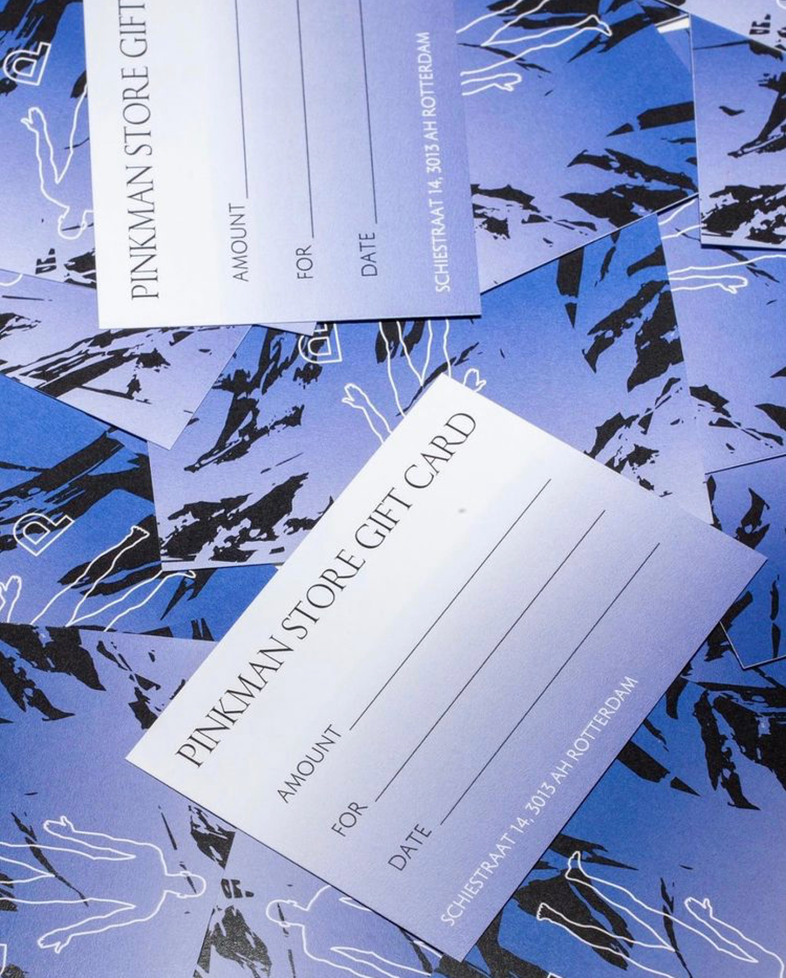 Pinkman Store gift cards on a blue patterned background