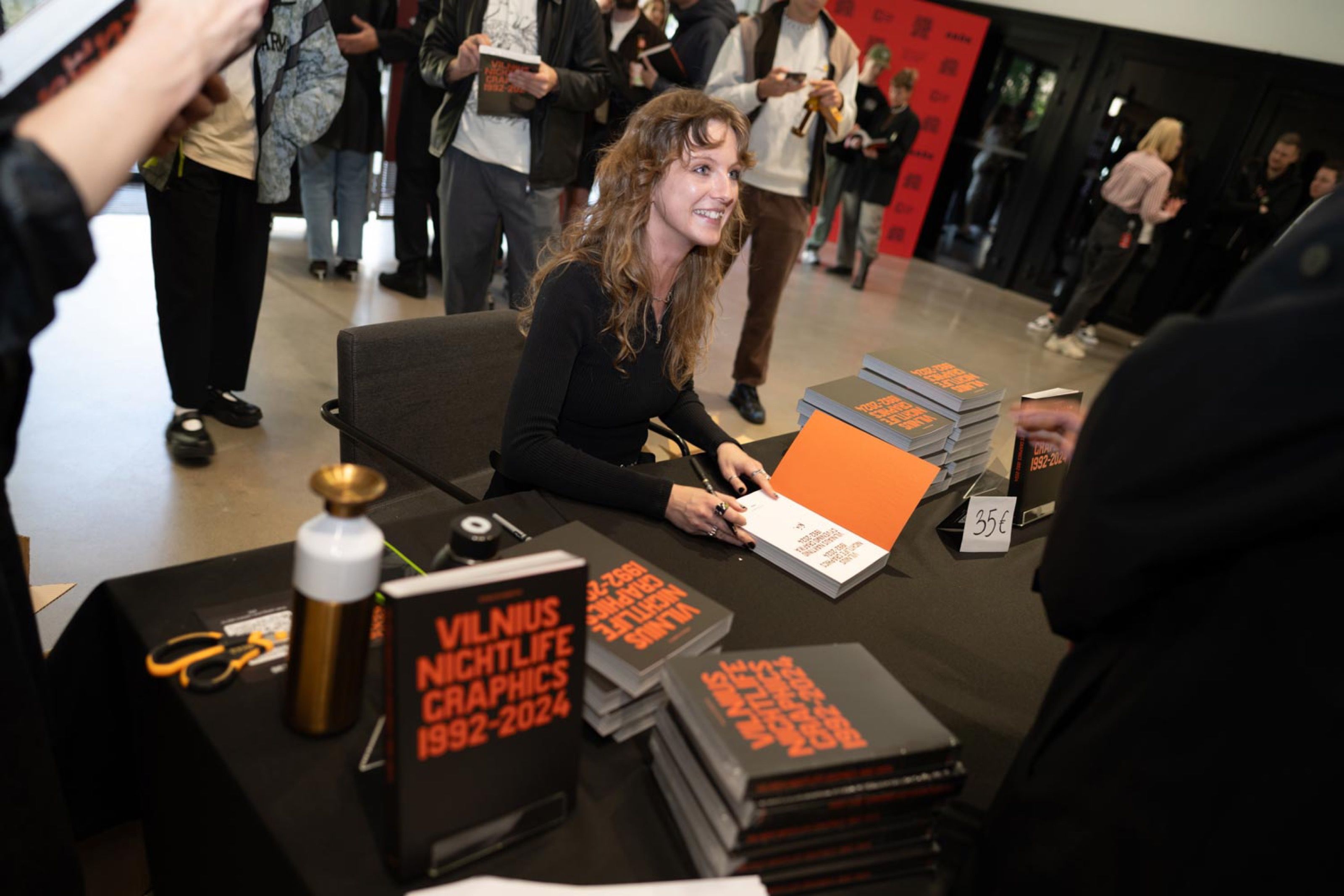 Ringailė Demšytė signing copies of Vilnius Nightlife Graphics 1992–2024