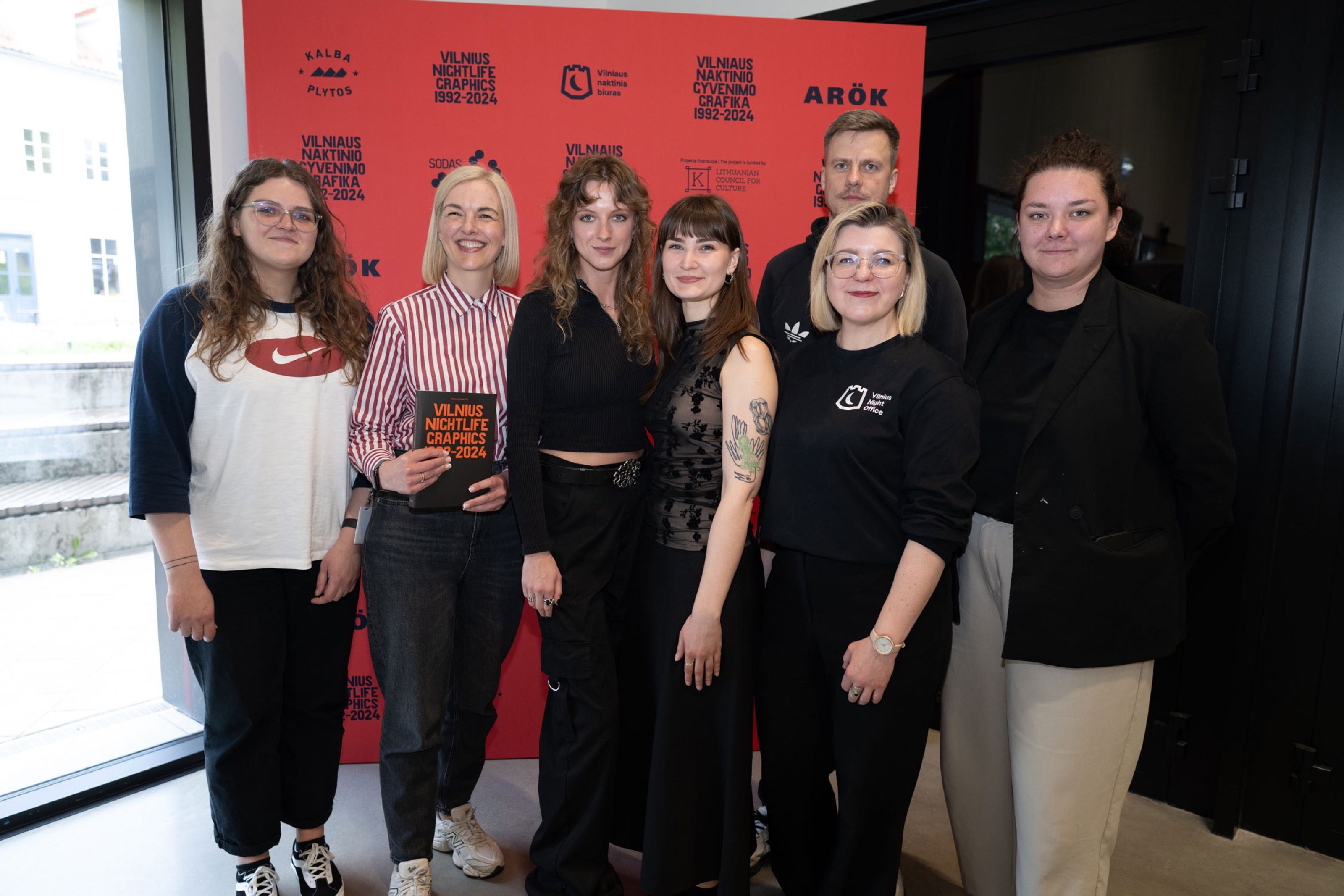 Group photo in front of the Vilnius Nightlife Graphics launch backdrop