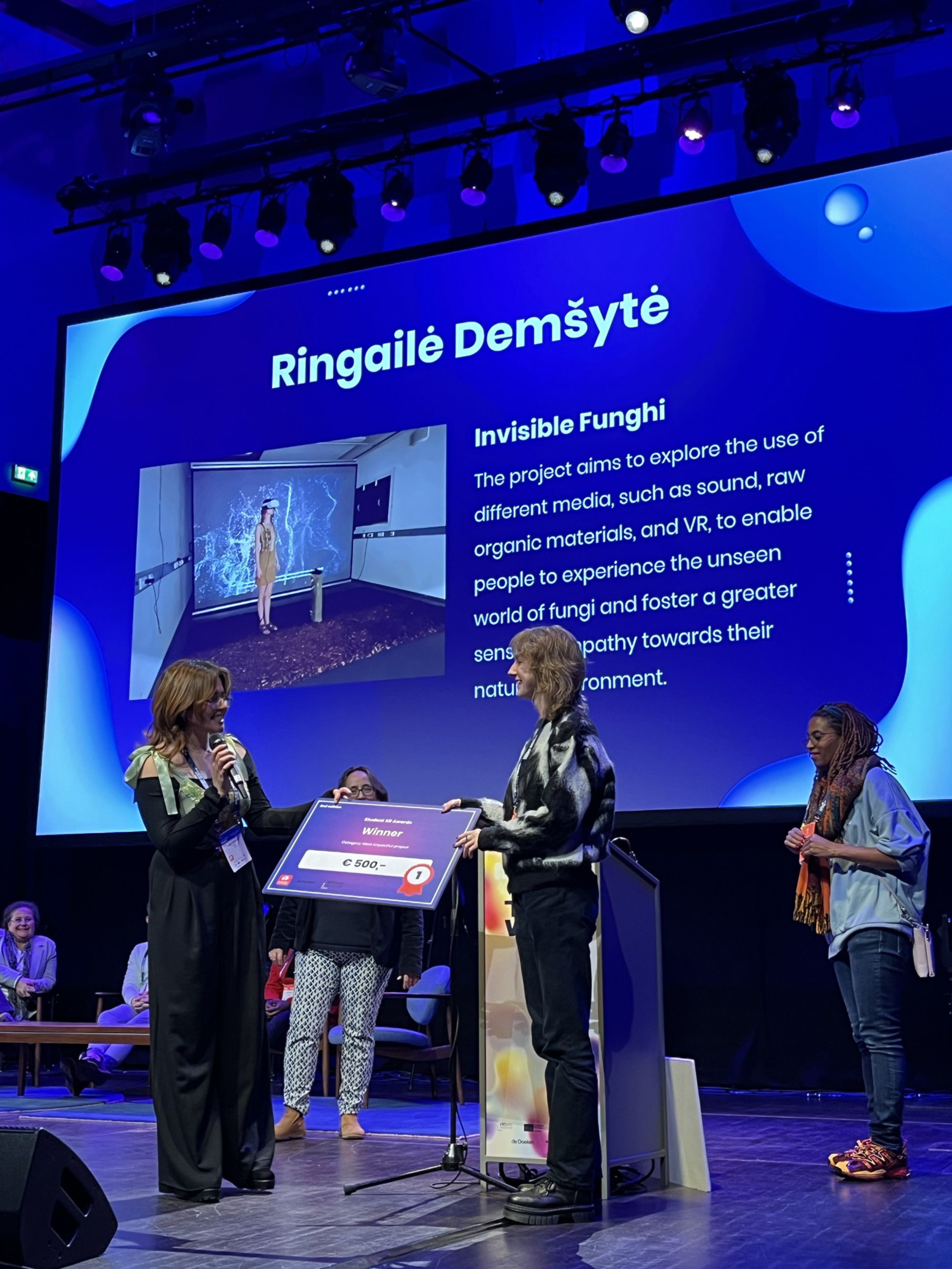Ringailė Demšytė receiving an award for Invisible Fungi on stage