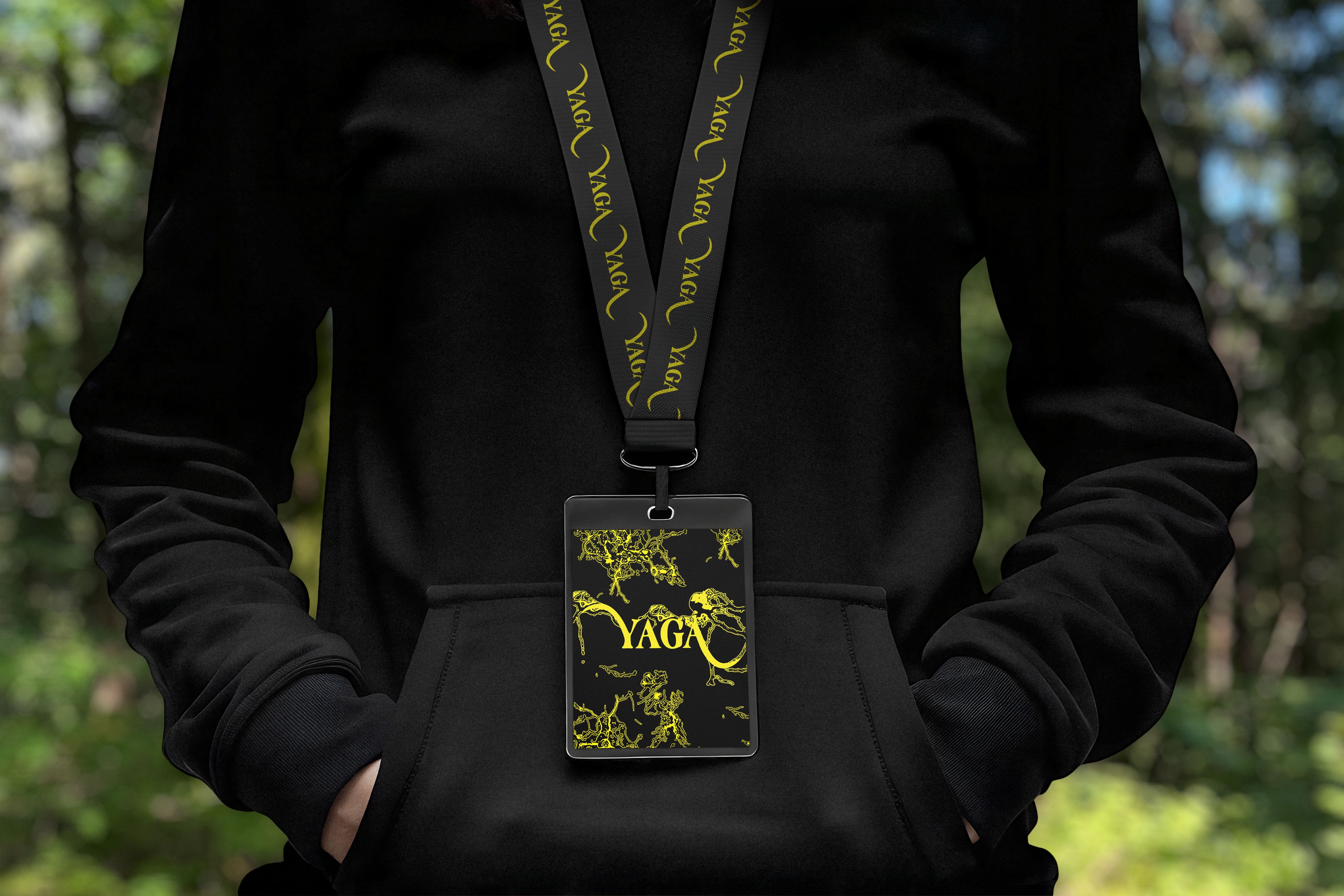 A person wearing a YAGA lanyard and festival pass