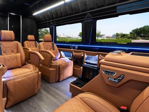 Executive Sprinter interior with tan leather captain chairs