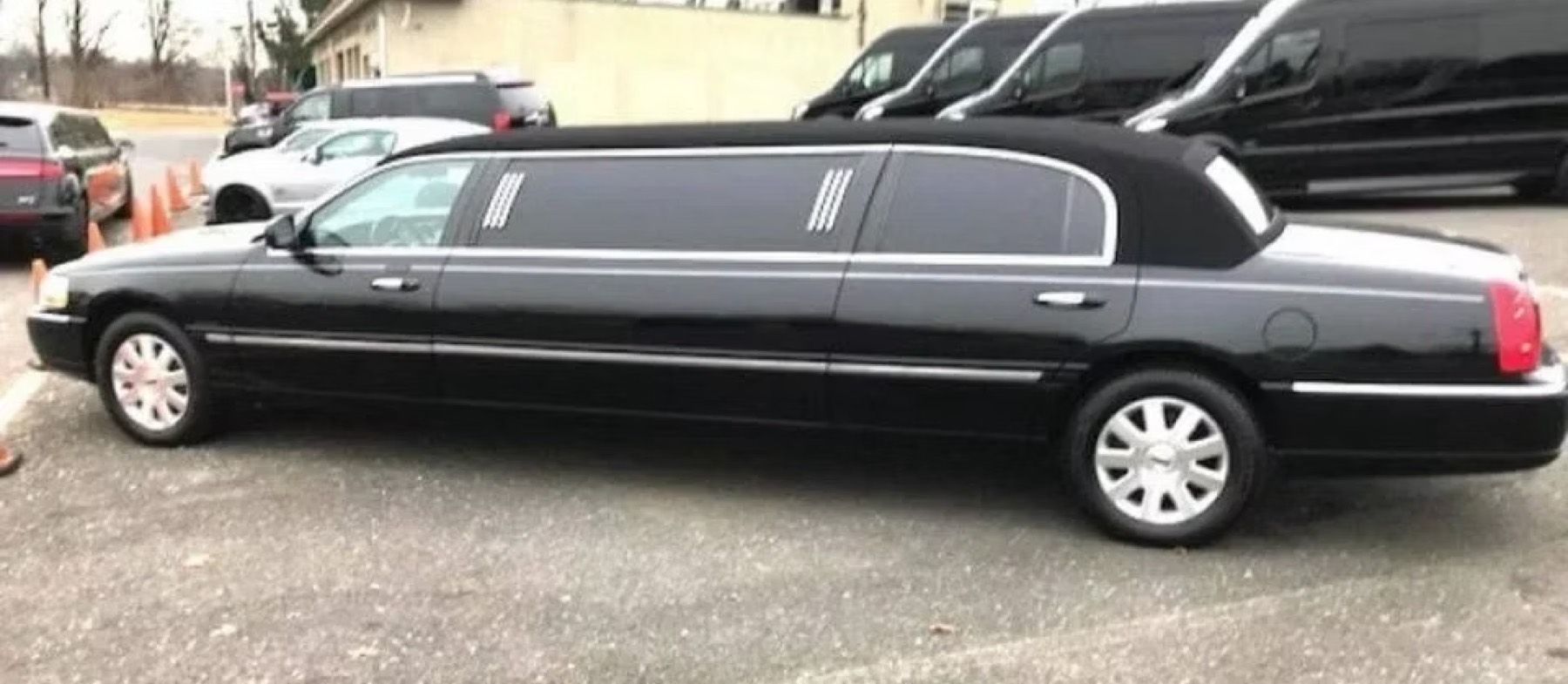 Black stretch limousine at night