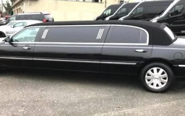 Black stretch limousine at night