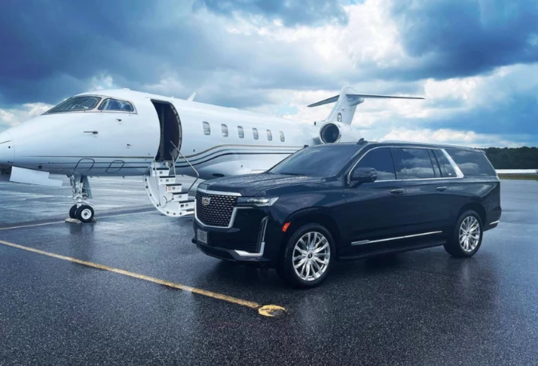 Cadillac Escalade beside a private jet