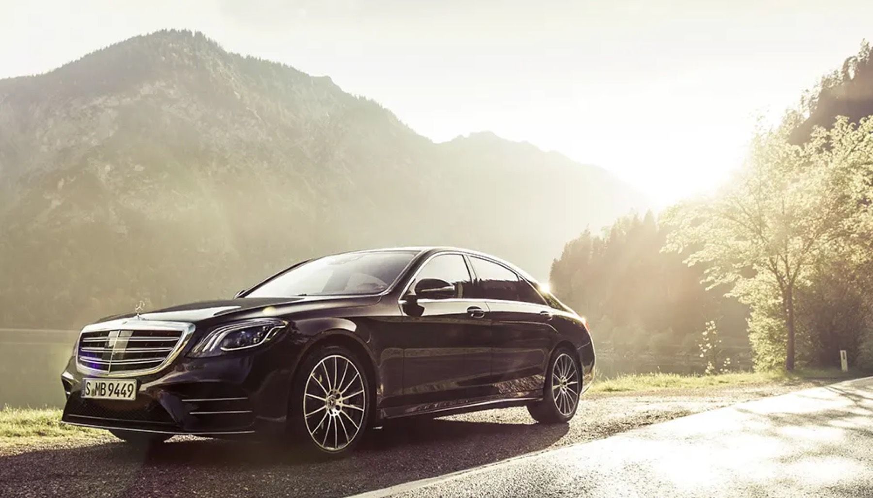 Black chauffeured sedan at the kerb
