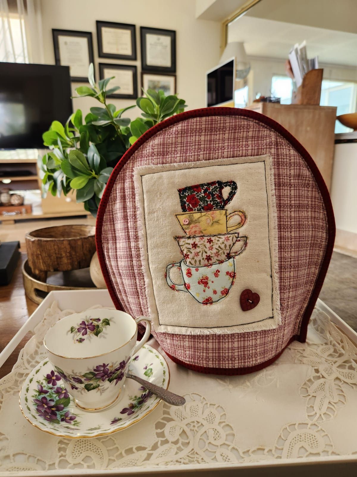 Rose plaid tea cosy with a stack of appliqué teacups in scrap florals