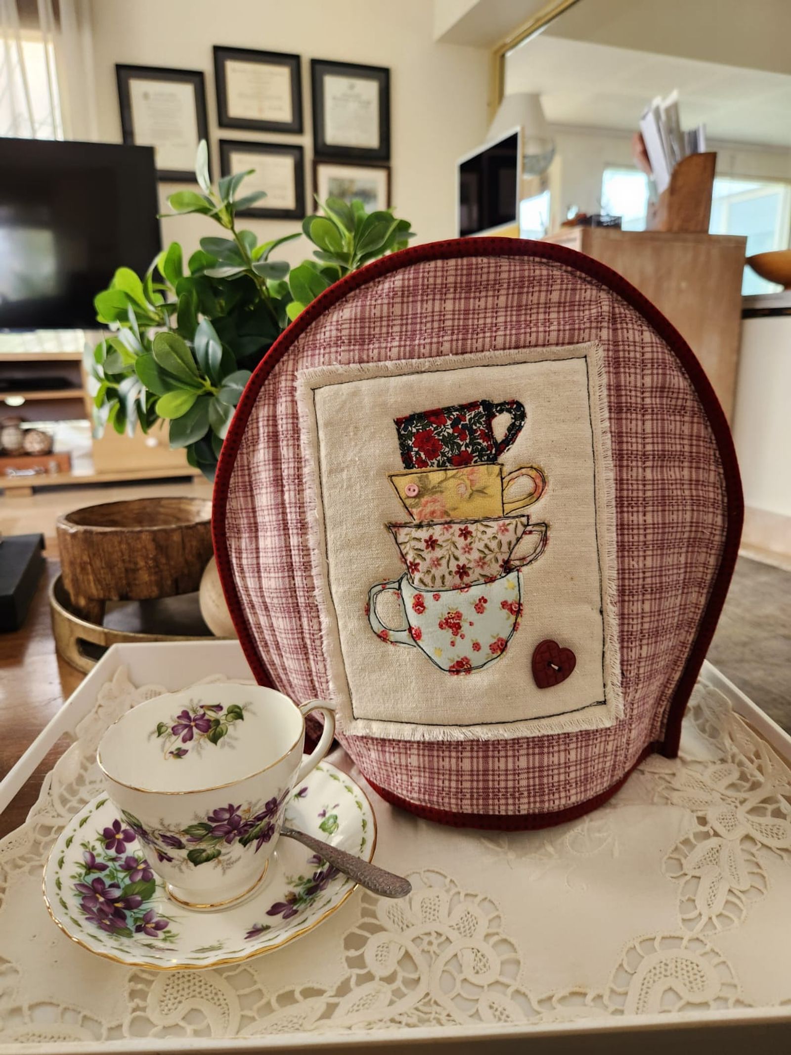 Rose plaid tea cosy with a stack of appliqué teacups in scrap florals