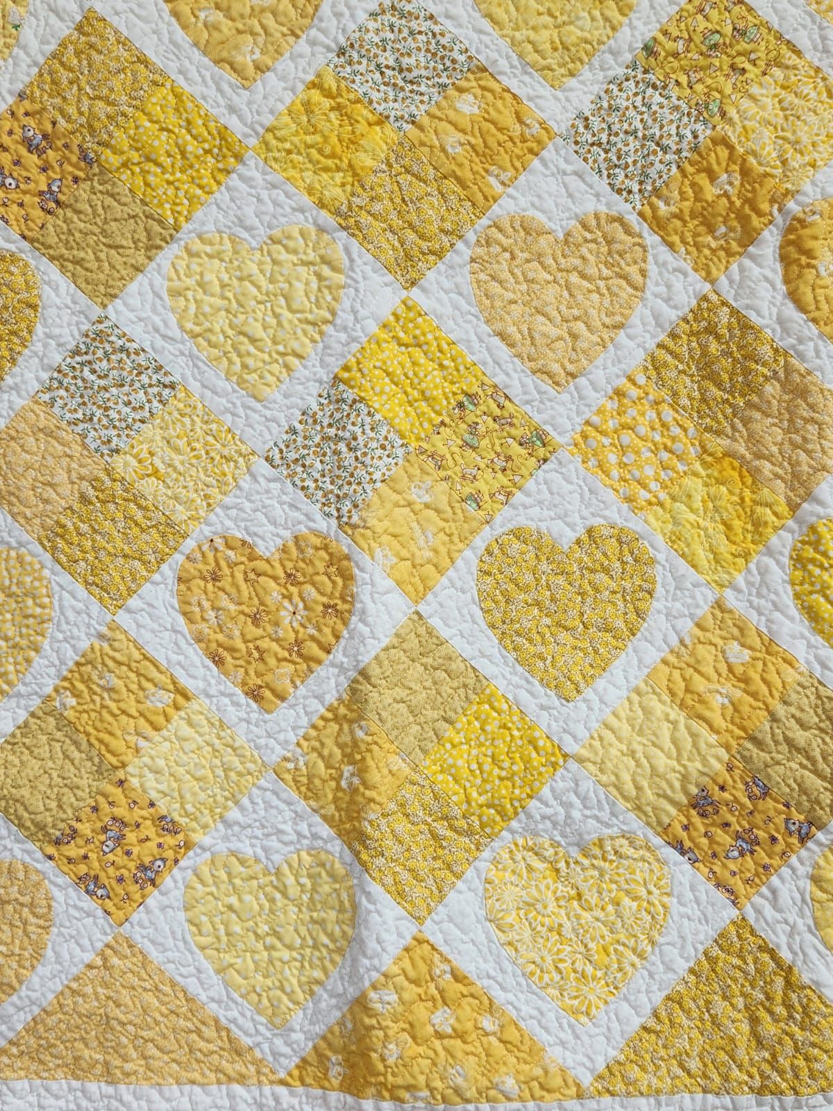 Close-up detail of the pieced gold heart blocks