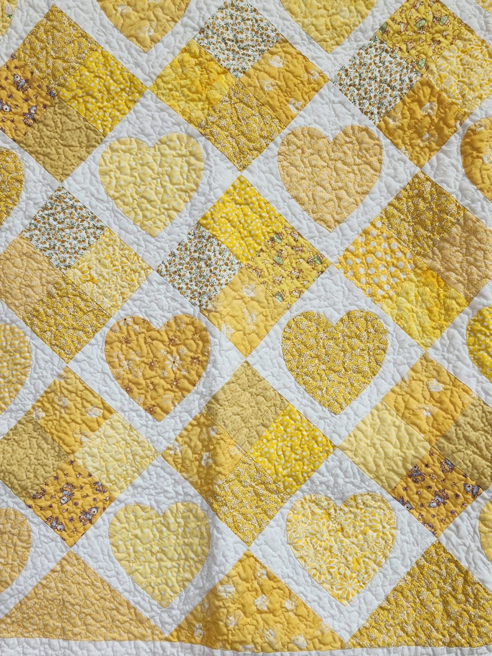 Close-up detail of the pieced gold heart blocks