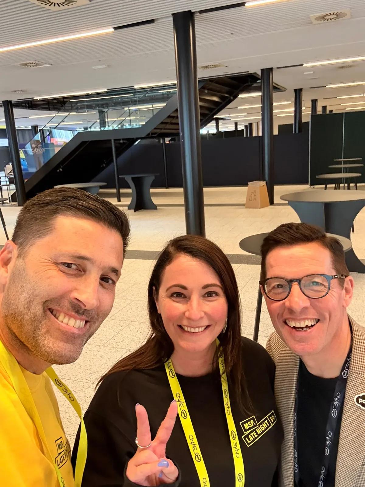Selfie with the MSP Late Night team, three people with yellow lanyards in the hall of the Bella Center