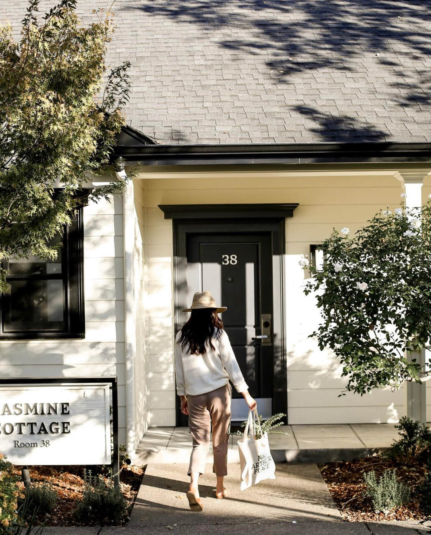 Guest arrival at MacArthur Place Hotel & Spa, a luxury boutique hotel in Sonoma, California, showing one of the property’s individual cottage accommodations and landscaped grounds. Love & War developed the brand strategy, visual identity and guest experience for MacArthur Place, extending the hospitality brand across signage, guest materials, amenities and touchpoints throughout the property to create a relaxed expression of natural luxury rooted in Sonoma Wine Country.