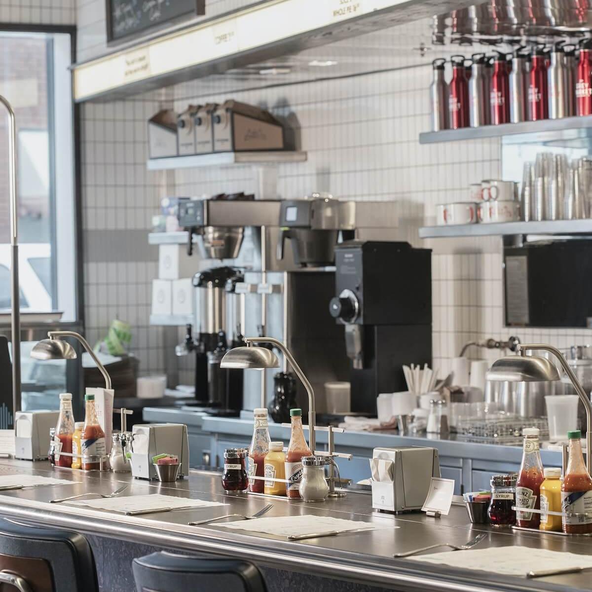 The Grey Market lunch counter in Savannah, GA, reflecting the restaurant brand and experience developed by Love & War.