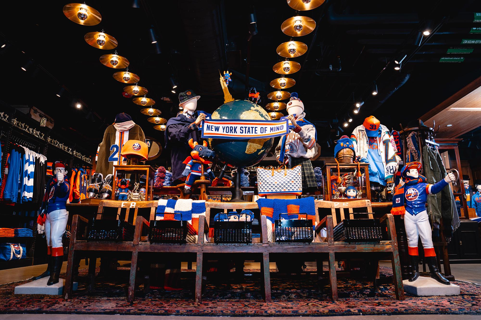 Interior of Isles Lab at UBS Arena, featuring a curated mix of New York Islanders apparel, accessories, collectibles and exclusive merchandise. Love & War developed the Isles Lab concept, name, branding and merchandise program, reimagining the traditional NHL team store as a fashion-forward retail and cultural experience for Islanders fans.