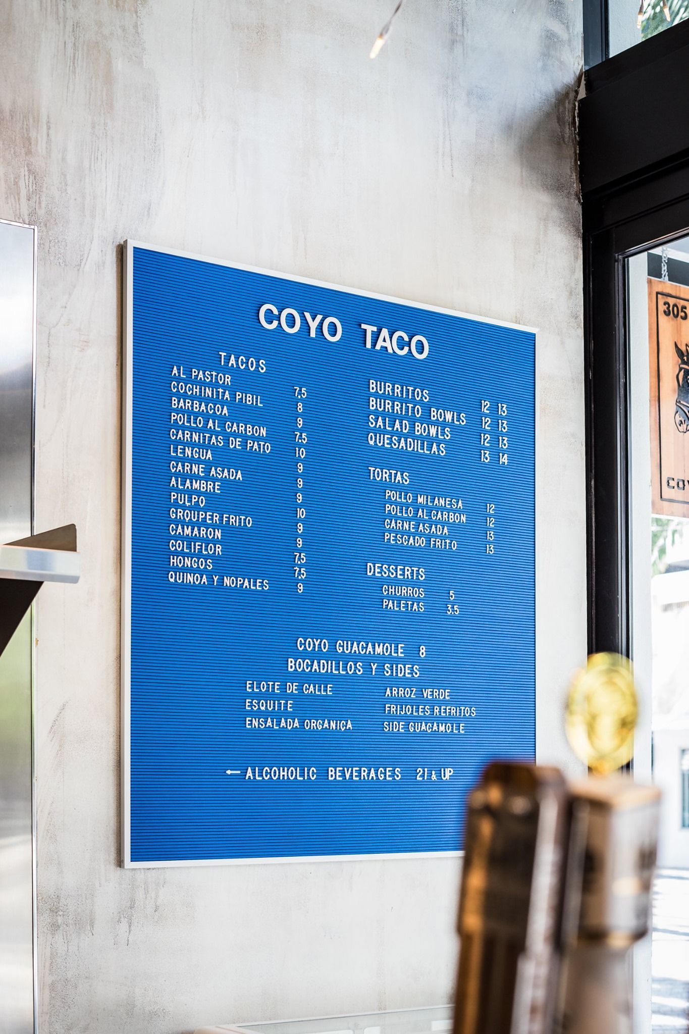 Coyo Taco menu board in Wynwood, Miami, featuring signage and visual identity designed by Love & War.