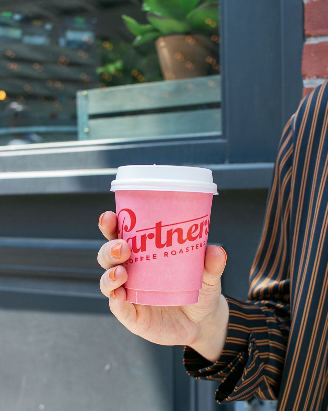 Partners Coffee cup, branding by Love & War for the Partners Coffee