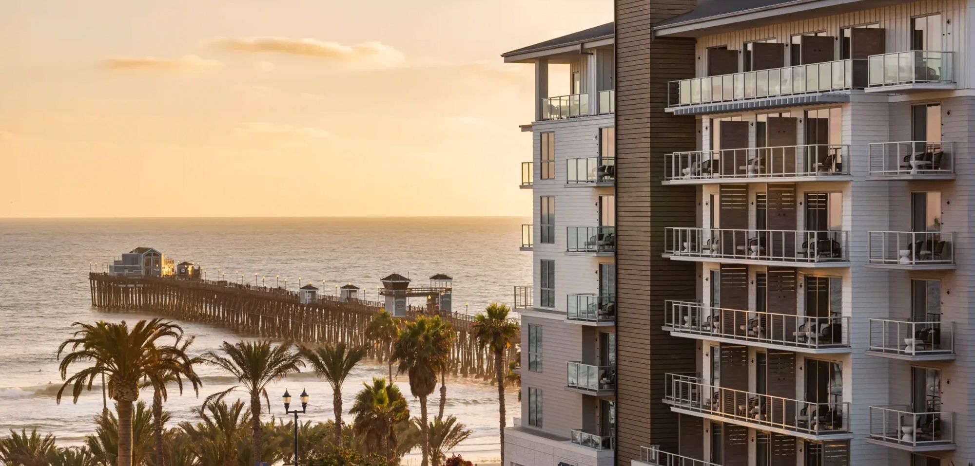 Oceanfront view of Mission Pacific Beach Resort in Oceanside, California, overlooking the historic Oceanside Pier. Love & War led the hospitality branding from concept and naming through visual identity, experience design, and marketing, creating a distinctive Southern California hotel brand inspired by Oceanside’s coastal setting and emerging creative culture.