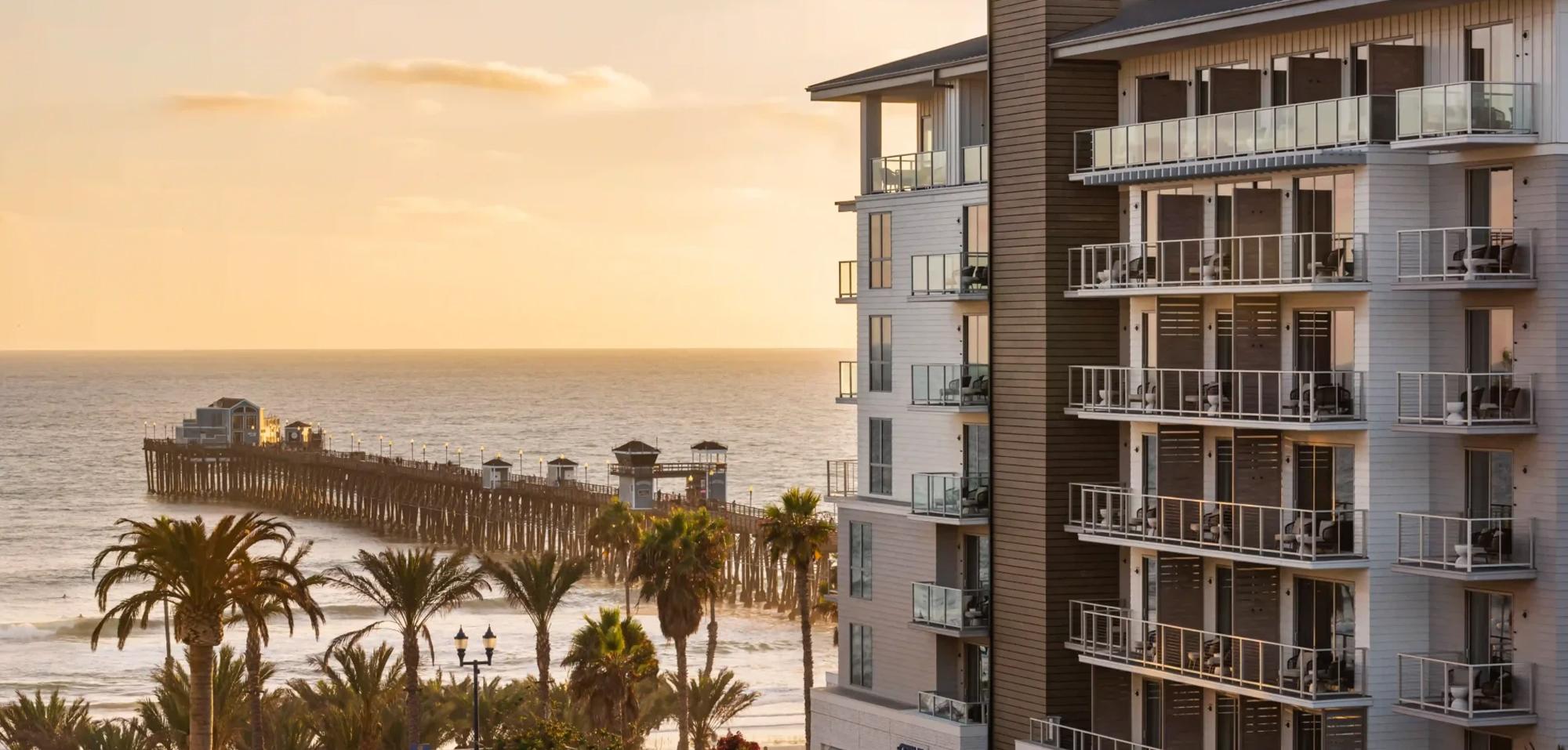 Oceanfront view of Mission Pacific Beach Resort in Oceanside, California, overlooking the historic Oceanside Pier. Love & War led the hospitality branding from concept and naming through visual identity, experience design, and marketing, creating a distinctive Southern California hotel brand inspired by Oceanside’s coastal setting and emerging creative culture.