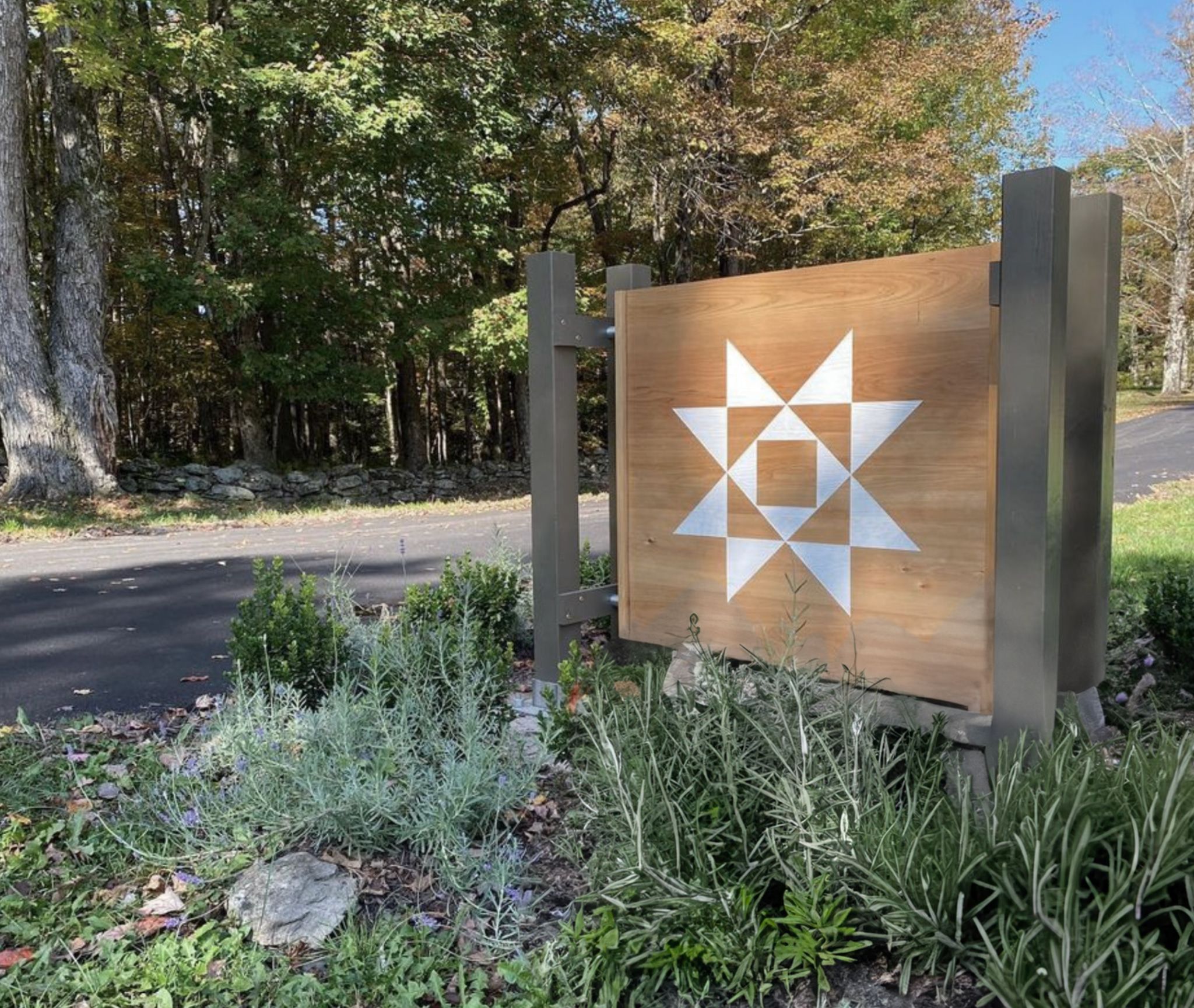 Hemlock Neversink entrance sign featuring the custom brand mark developed by Love & War for the Catskills wellness retreat.
