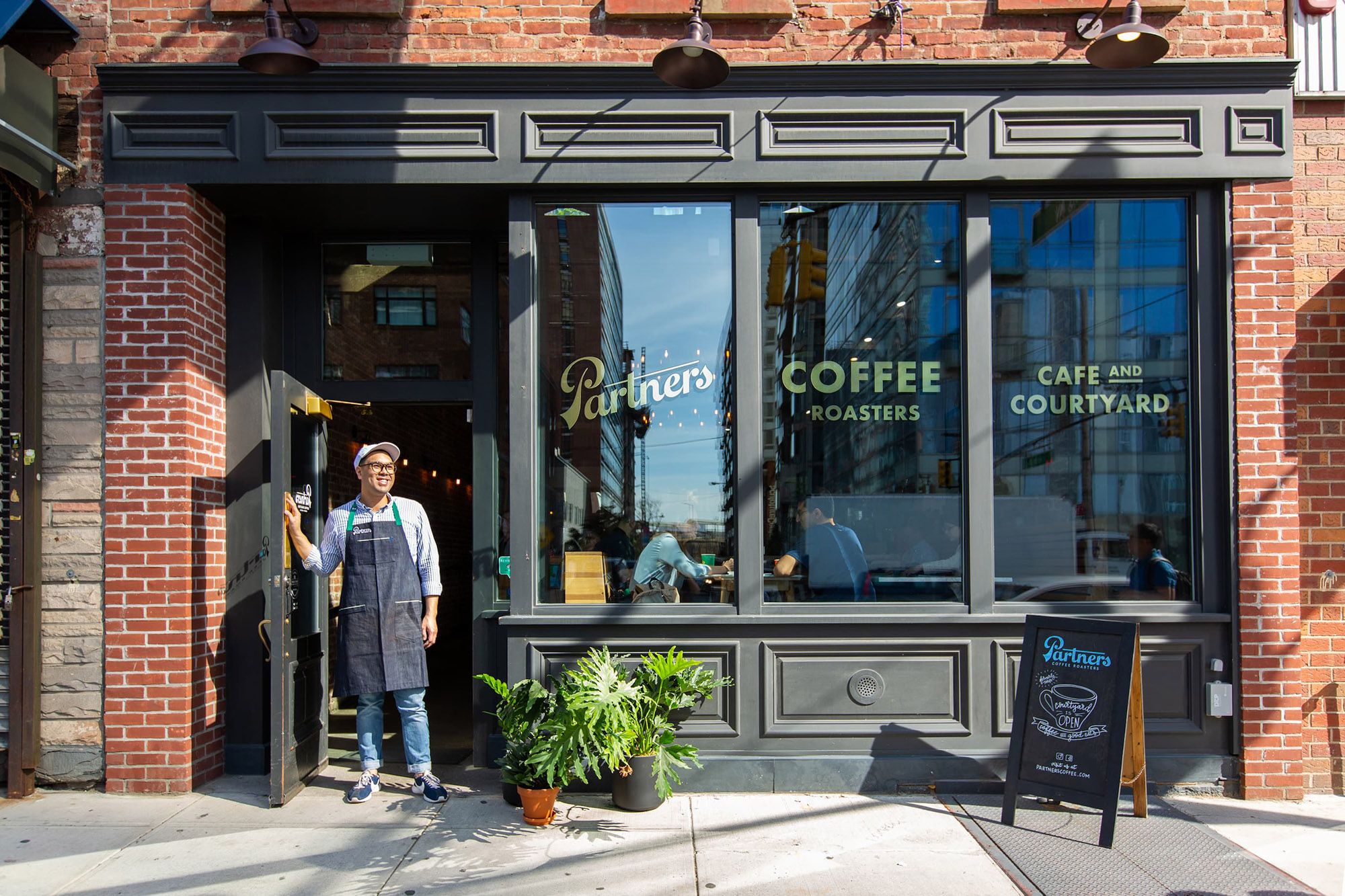 Partners Coffee café in Long Island City featuring storefront signage and brand identity by Love & War.
