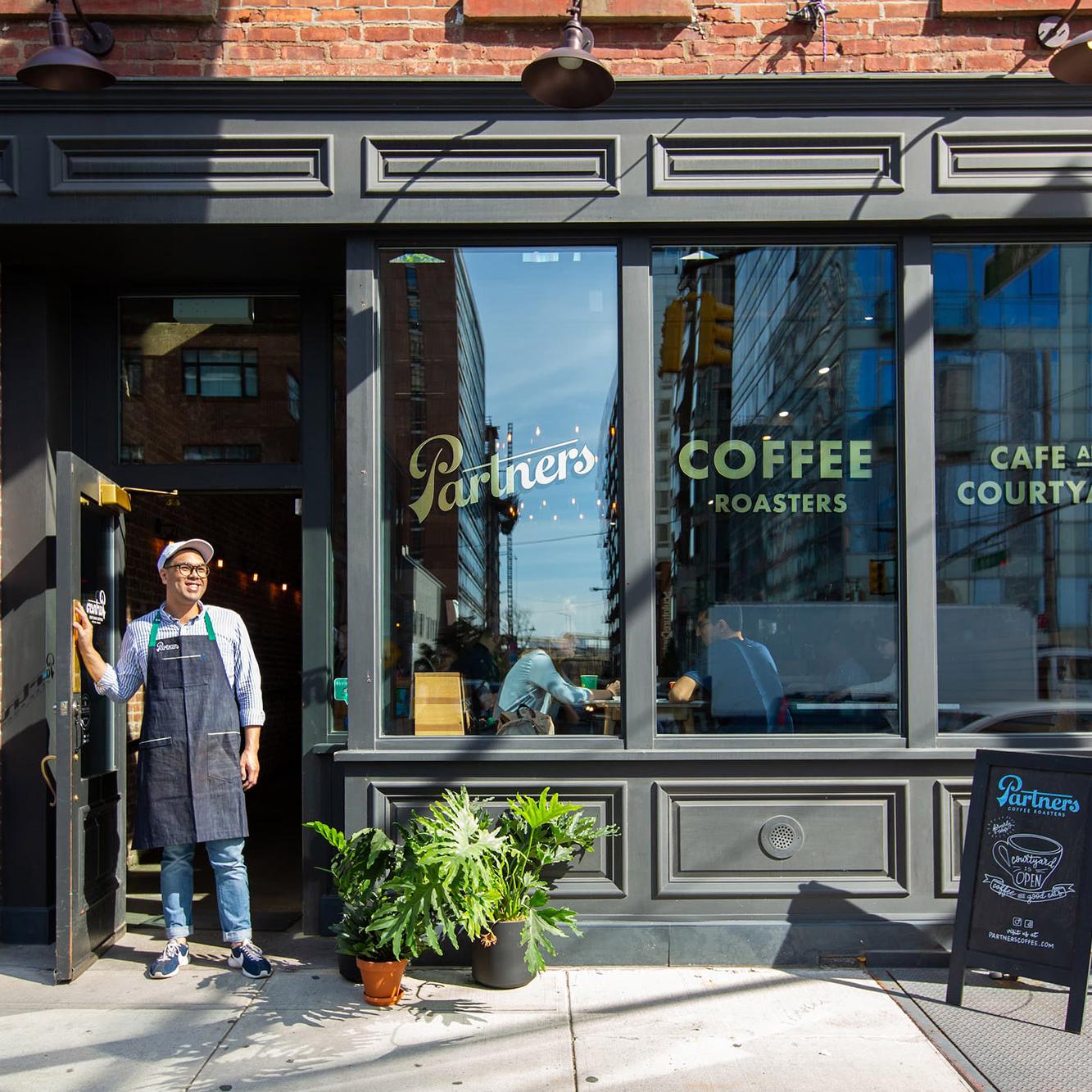 Partners Coffee café in Long Island City featuring storefront signage and brand identity by Love & War.