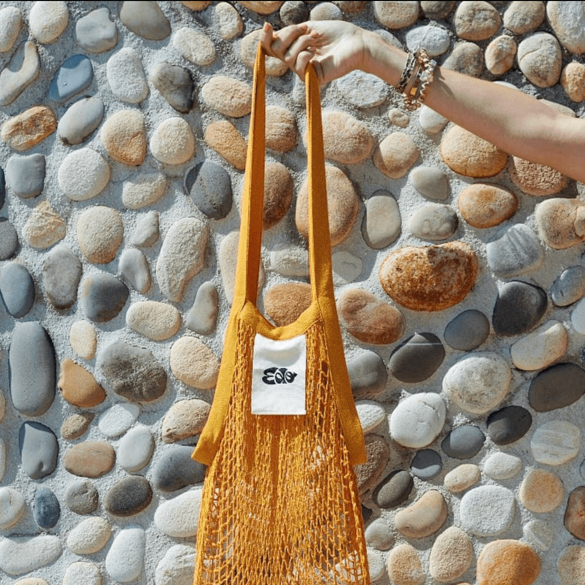 EDO branded merchandise featuring a custom logo label on a woven market bag, extending Michelin-starred chef Mory Sacko’s traveling food concept into lifestyle and fashion. Love & War developed the brand strategy, visual identity and branded merchandise for EDO, creating a distinctive hospitality brand inspired by West African food, global street culture, music and contemporary design.