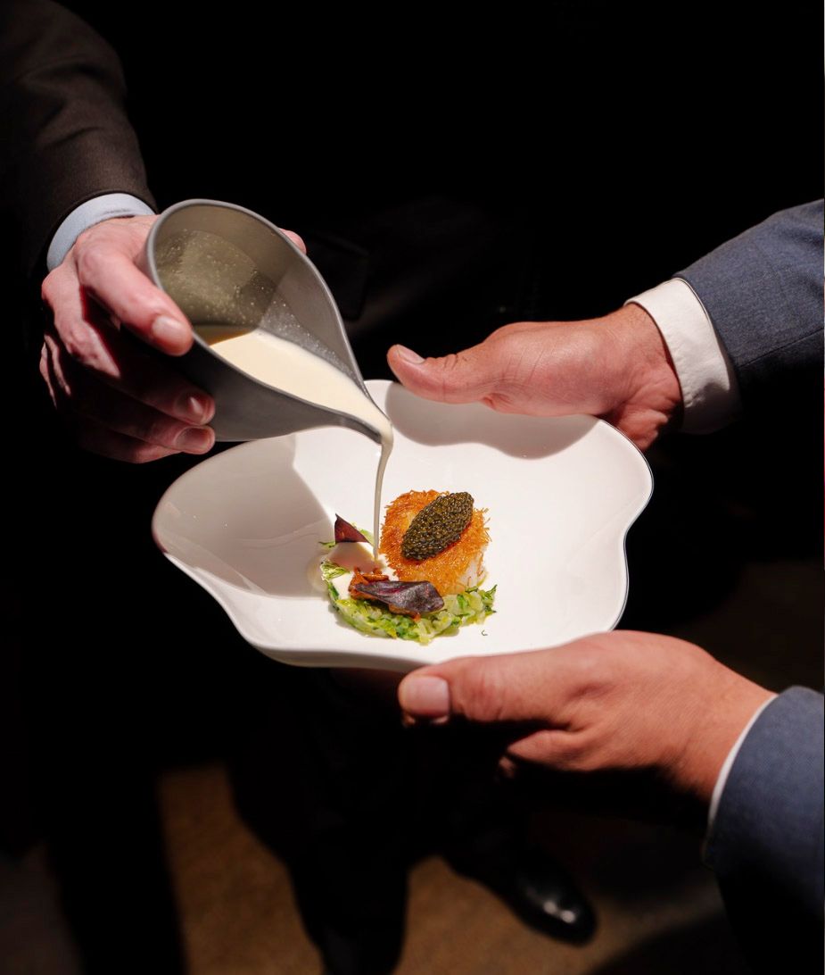 A plated dish being finished tableside at Le Pavillon, Daniel Boulud’s flagship restaurant at One Vanderbilt in New York City.