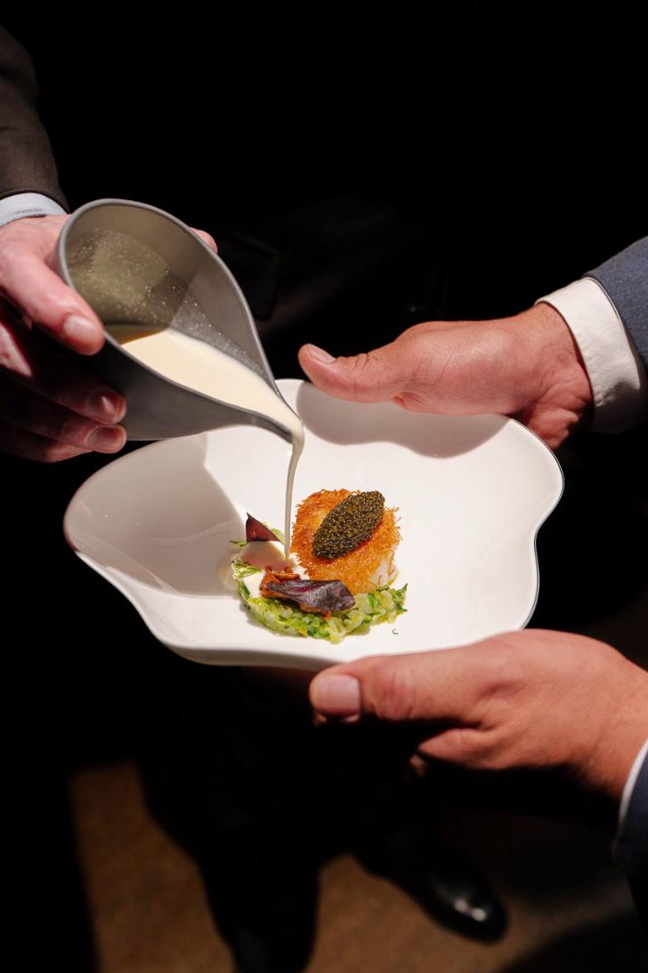 A plated dish being finished tableside at Le Pavillon, Daniel Boulud’s flagship restaurant at One Vanderbilt in New York City.