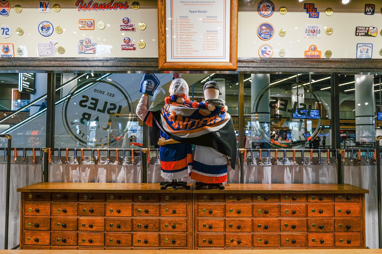 Interior of Isles Lab at UBS Arena featuring New York Islanders memorabilia, vintage-inspired graphics and the team’s mascots within the store’s distinctive retail environment. Love & War developed the Isles Lab concept, naming, branding and merchandise program, creating a New York Islanders retail experience rooted in team history, fan culture and contemporary design.