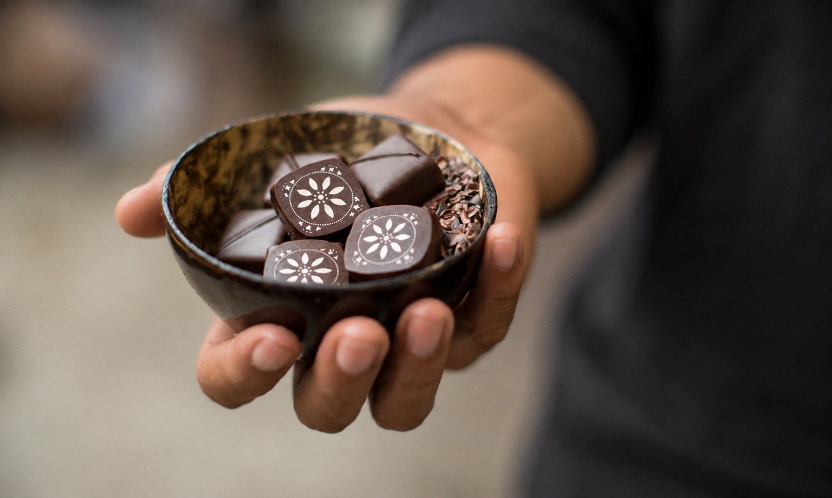 Custom chocolates at Valle in Oceanside, CA, featuring the restaurant’s floral brand mark designed by Love & War.