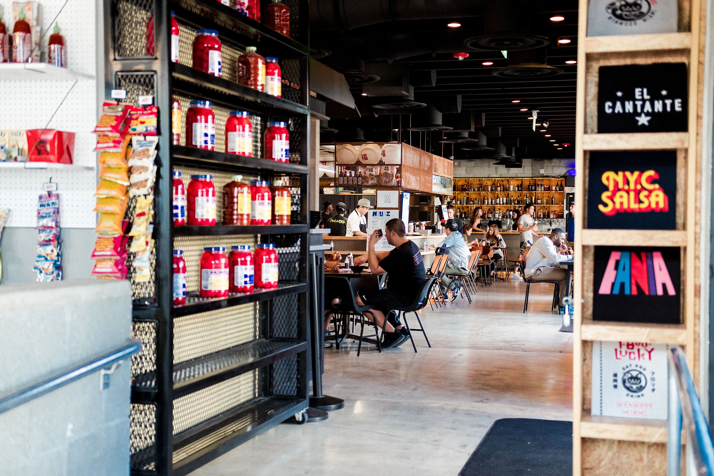Interior of 1-800-Lucky in Wynwood, Miami, showing food vendors, communal seating and the open Asian food hall environment.