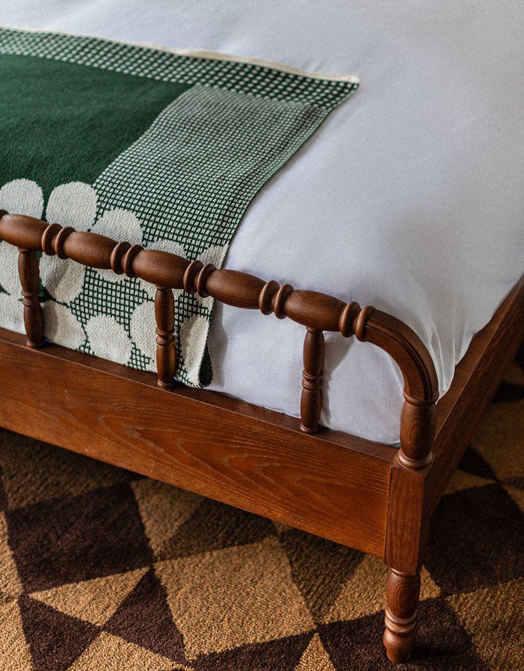 Hemlock Neversink guest room featuring a custom blanket inspired by the Love & War-designed brand identity.