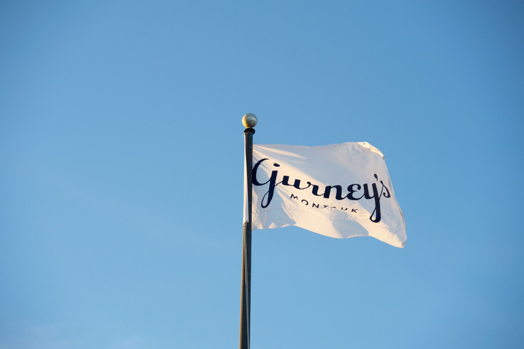 Gurney’s Montauk flag featuring the visual identity developed by Love & War for the Hamptons resort.