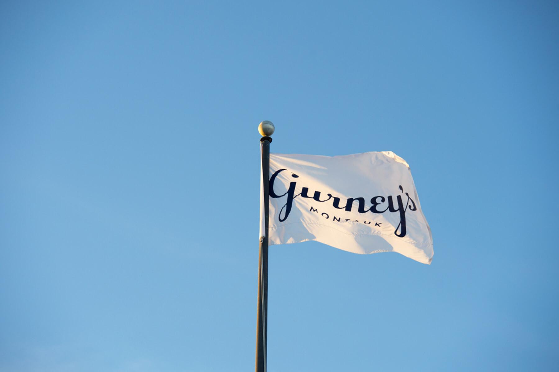 Gurney’s Montauk flag featuring the visual identity developed by Love & War for the Hamptons resort.