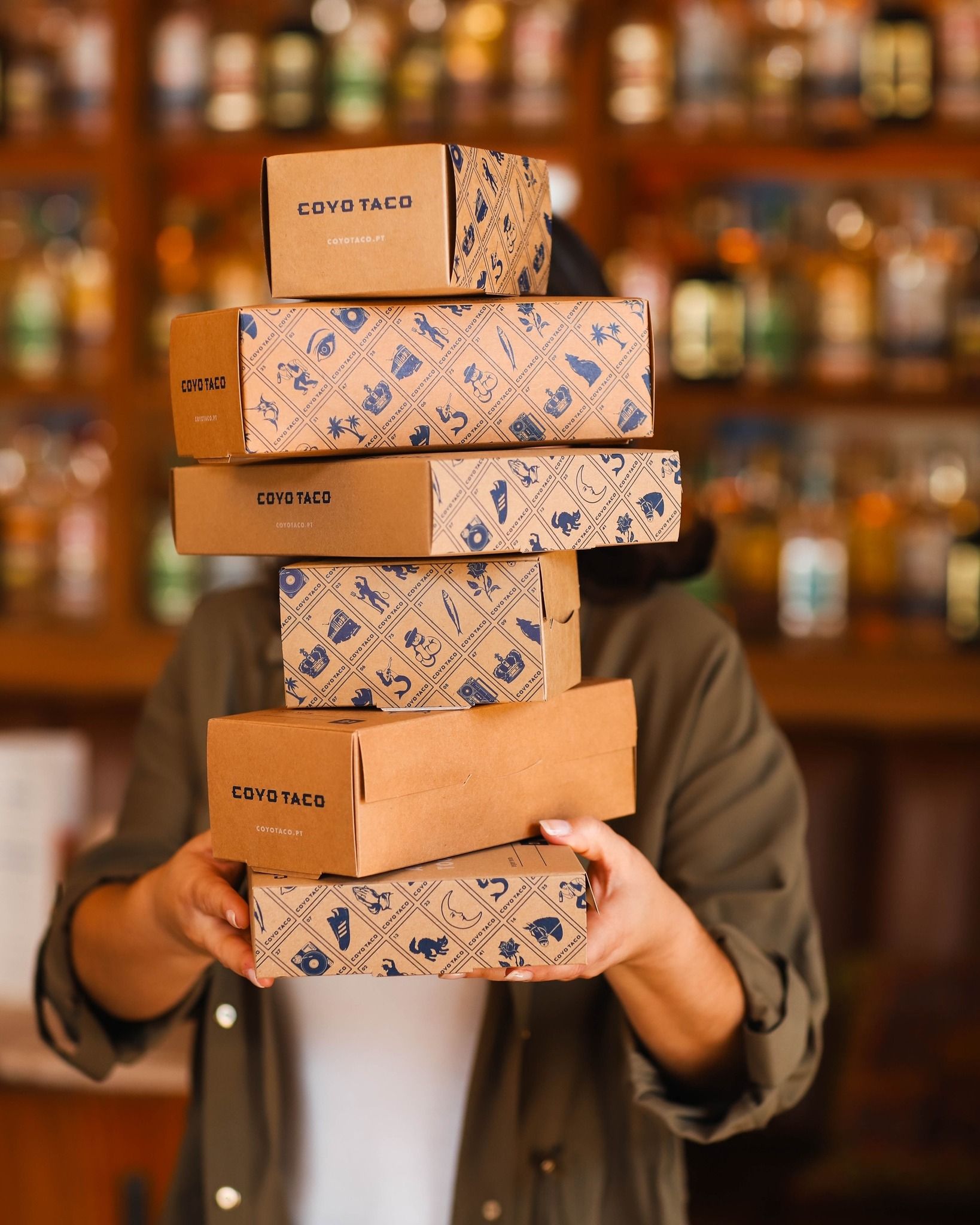 Coyo Taco takeout boxes featuring custom packaging and visual identity designed by Love & War.
