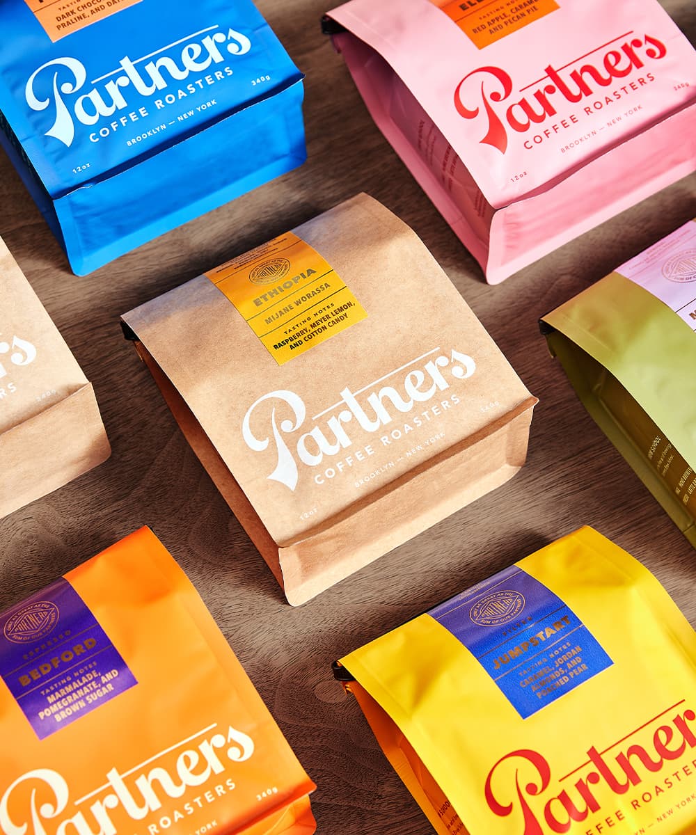 Partners Coffee packaging system featuring the colorful brand identity and packaging designed by Love & War.