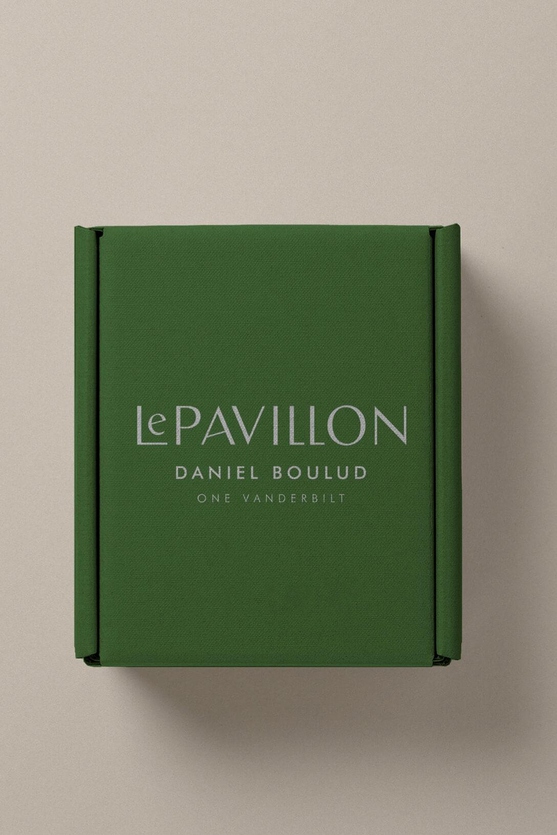 Custom green Le Pavillon packaging featuring the restaurant logo and visual identity developed by Love & War.