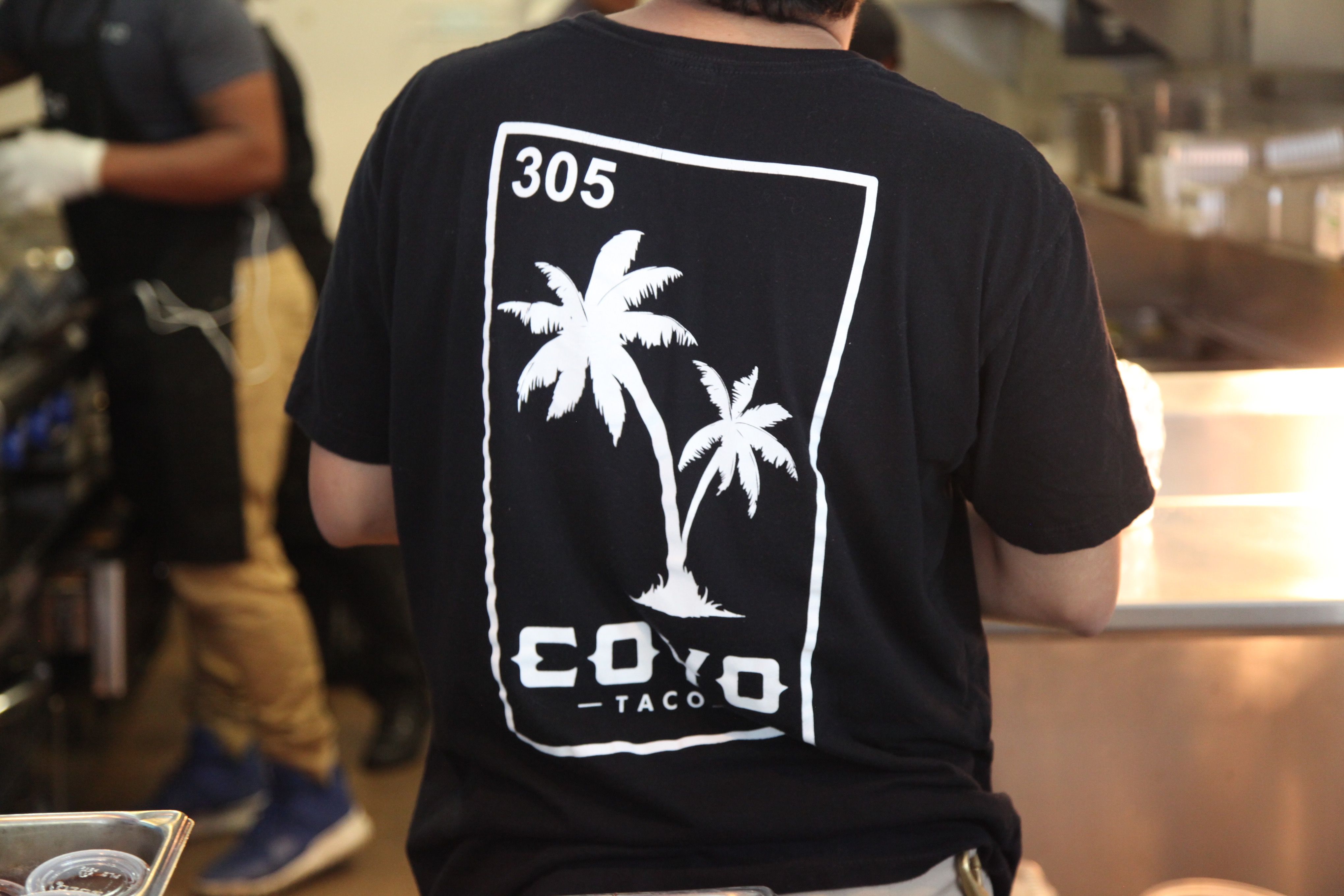 Coyo Taco staff shirt in Wynwood, Miami, featuring custom merchandise and visual identity designed by Love & War.