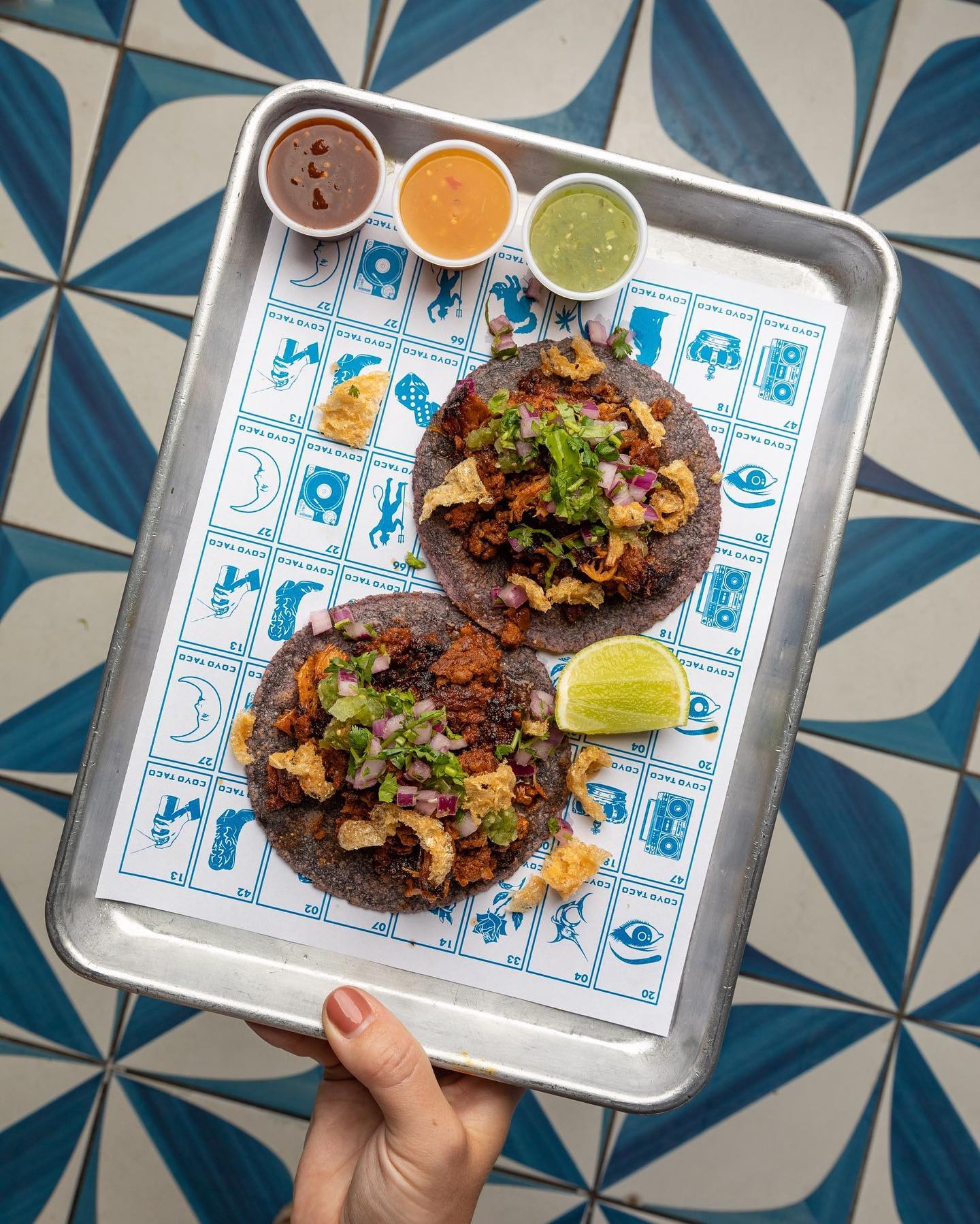 Coyo Taco tacos in Wynwood, Miami, served on custom branded paper featuring the visual identity by Love & War.