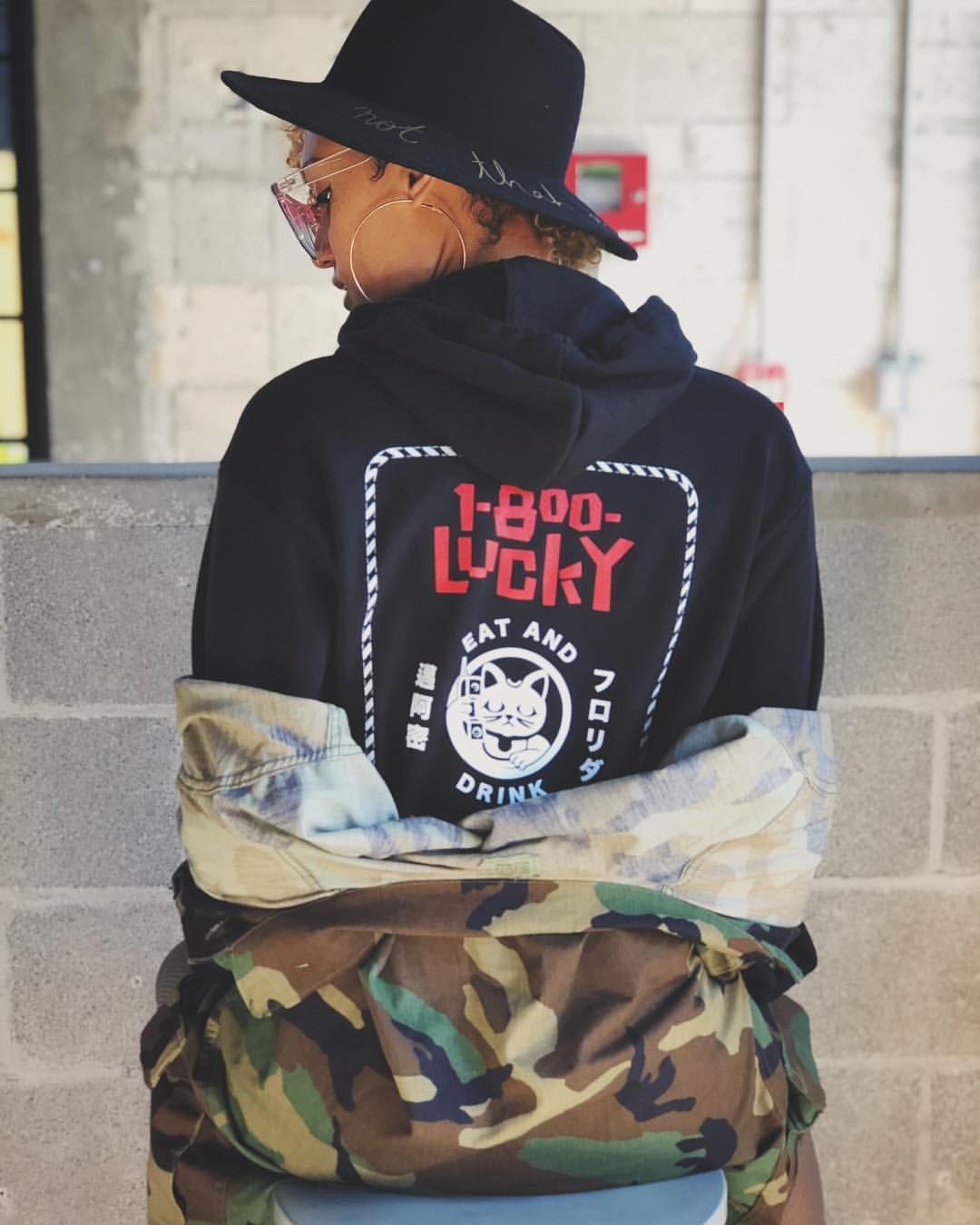 1-800-Lucky branded hoodie featuring the food hall’s Lucky Cat graphic, part of the visual identity created by Love & War.