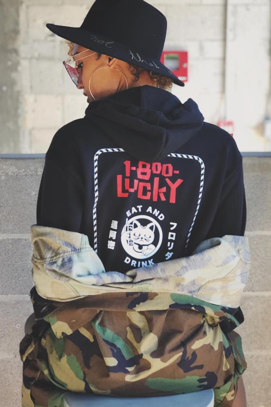 1-800-Lucky branded hoodie featuring the food hall’s Lucky Cat graphic, part of the visual identity created by Love & War.