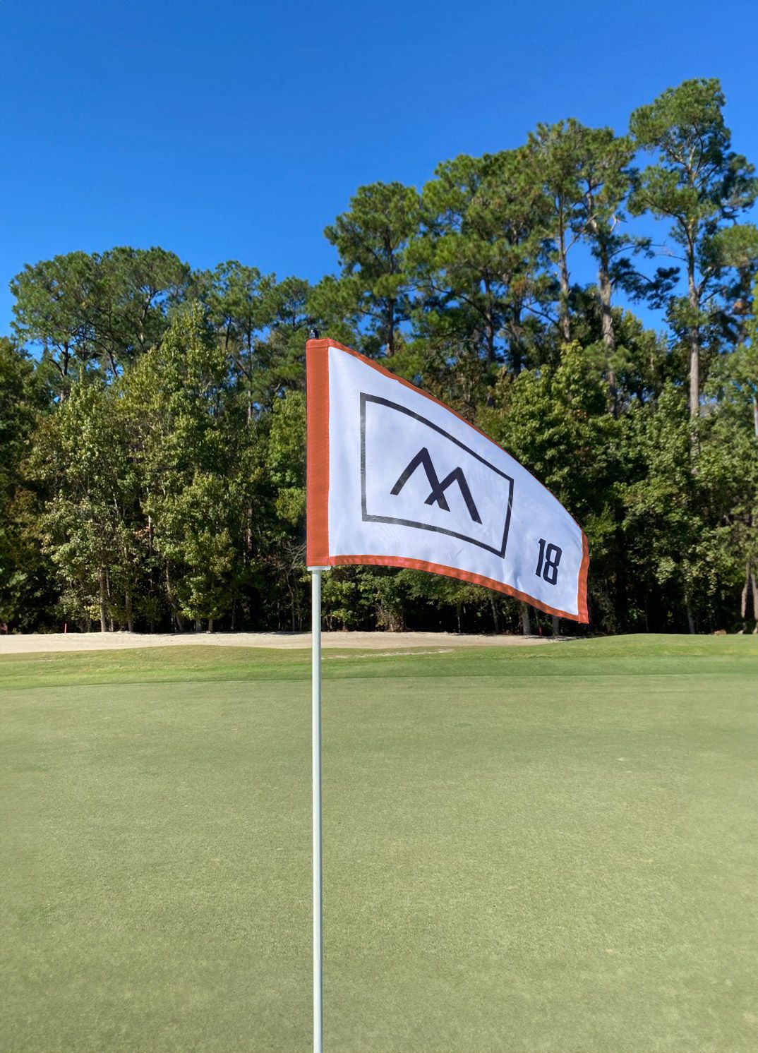 Moncayo golf course flag featuring the destination's brand identity on the championship golf course in Puerto Rico, designed by Love & War