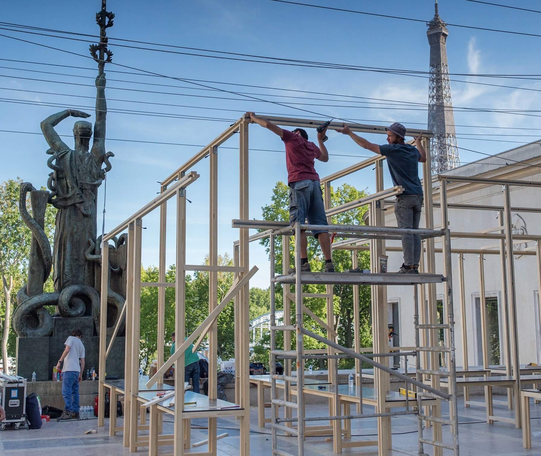 Construction of the EDO pop-up restaurant and dining pavilion in Paris, with the Eiffel Tower visible in the background. Love & War developed the brand strategy, visual identity and branded experience for EDO, Michelin-starred chef Mory Sacko’s traveling food concept, bringing the brand to life across its physical environment, apparel, merchandise and communications.