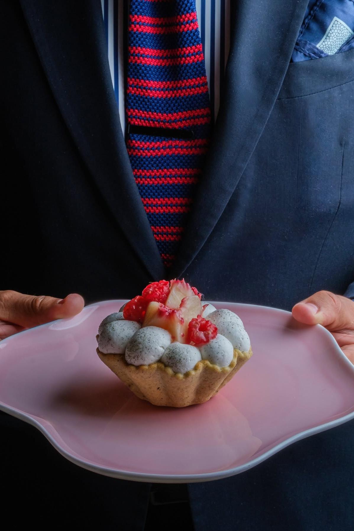 Le Pavillon dessert served on a sculptural pink plate, part of the dining experience at Daniel Boulud’s One Vanderbilt restaurant.