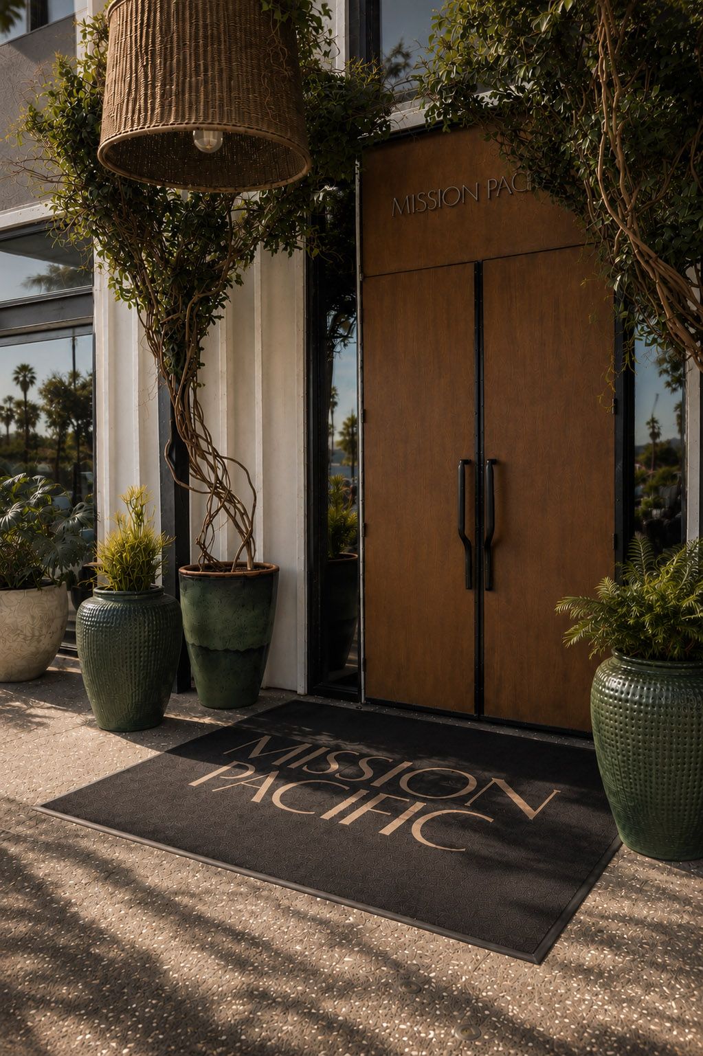 Entrance to Mission Pacific Beach Resort in Oceanside, California, featuring custom signage, natural wood doors, and drought-tolerant landscaping. Love & War developed the hotel’s concept, naming, visual identity, experience design, and marketing, creating a hospitality brand that brings relaxed Southern California luxury and Oceanside’s creative coastal character into every guest touchpoint.