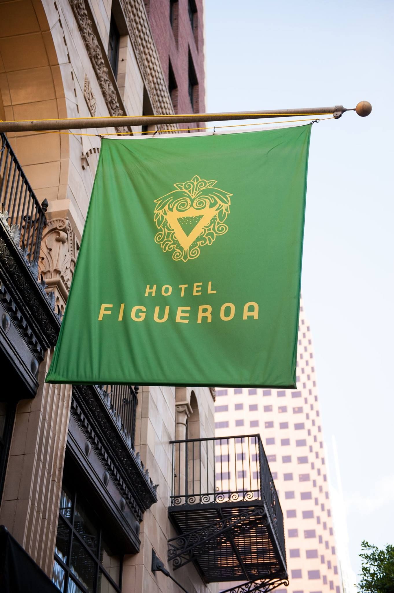 otel Figueroa exterior signage featuring the hotel’s custom logo and visual identity in Downtown Los Angeles (DTLA). Love & War developed the brand strategy, visual identity and guest materials for Hotel Figueroa, creating a distinctive hospitality brand inspired by the historic Los Angeles hotel’s architecture, cultural legacy and nearly century-long history.