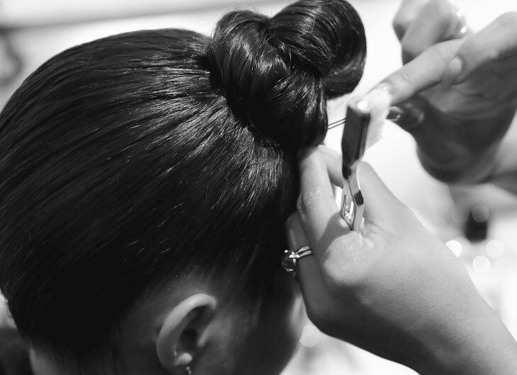 Stylist securing bun.