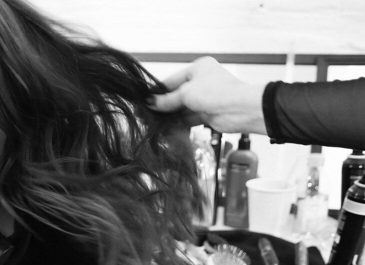 Styist applying TRESemmé Keratin Smooth Shine Serum to model's hair