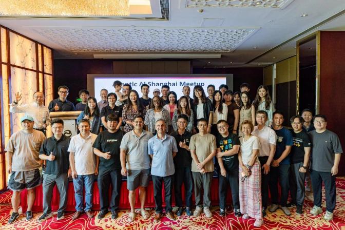 Group photo of attendees at the Agentic AI Shanghai Meetup posing together on stage in a hotel event room.